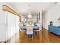 Bright dining room with hardwood floors, chandelier, and blue table at 2605 Seneca Ave, The Villages, FL 32162