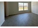 Bright living room featuring tile flooring, neutral walls, and a large window at 418 Central Ave, Frostproof, FL 33843