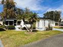 Charming single-story home featuring mature trees, and a meticulously maintained lawn at 102 Willow Ln, Leesburg, FL 34748