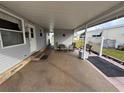 Covered patio with seating area and adjacent to the home at 110 Dogwood Trl, Leesburg, FL 34748