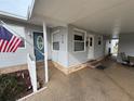 Front view of manufactured home with covered entry and landscaping at 110 Dogwood Trl, Leesburg, FL 34748