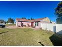 View of the home's side, showcasing a patio and lawn at 1273 Tyler Lake Cir, Orlando, FL 32839