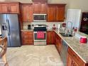 Well-equipped kitchen with stainless steel appliances and granite countertops at 1273 Tyler Lake Cir, Orlando, FL 32839