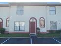 Townhome exterior featuring a red door and neutral color scheme at 1608 Long Ridge Ct # 274, Orlando, FL 32807