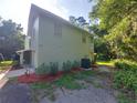 Side view of house showcasing green exterior and landscaping at 253 N Blue Lake Ave, Deland, FL 32724