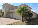 Two-story house with a three-car garage and side yard view at 2802 Quiet Water Trl, Kissimmee, FL 34744