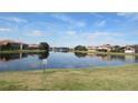 Community lake view with houses reflecting in the water at 2802 Quiet Water Trl, Kissimmee, FL 34744