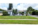 Single story home with gray brick and a nicely landscaped lawn at 2809 Bower Rd, Winter Park, FL 32792