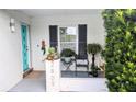 Inviting front porch with teal door and potted plants at 2809 Bower Rd, Winter Park, FL 32792