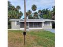 Cute ranch home with a screened porch and mature landscaping at 325 Garden St, Daytona Beach, FL 32114