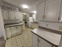 Quaint kitchen featuring white cabinets and patterned floor at 3376 Se 94Th St, Ocala, FL 34480