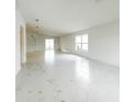 Bright living room features marble floors, natural light, and neutral paint palette at 3556 Elliot Pl, Bartow, FL 33830