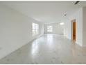 Bright living room features marble floors, natural light, and neutral paint palette at 3556 Elliot Pl, Bartow, FL 33830