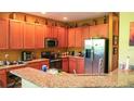 Spacious kitchen featuring stainless steel appliances and granite countertops at 4055 Beacon Ridge Way, Clermont, FL 34711