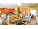 Bright living room with comfortable seating and a view into the kitchen at 4055 Beacon Ridge Way, Clermont, FL 34711