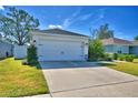 White house exterior with a two-car garage at 4481 Reding Way, Lakeland, FL 33813