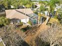 Aerial view of property, showcasing the screened pool enclosure and lush surrounding landscape at 766 Bryson Loop, Lakeland, FL 33809