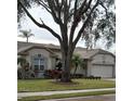 House with mature landscaping and a large tree in the front yard at 766 Bryson Loop, Lakeland, FL 33809