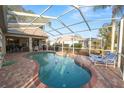 Screened-in pool area with brick pavers, lounge chairs, and view of backyard at 766 Bryson Loop, Lakeland, FL 33809