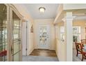 Bright entryway with glass-paned door and hardwood floors at 108 Dogwood Trl, Leesburg, FL 34748