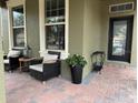 Inviting front porch with wicker chairs and lush landscaping at 16310 Wind View Ln, Winter Garden, FL 34787