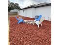 Relaxing backyard with firepit and wood chips at 203 Juniper Way, Ocala, FL 34480