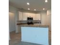 Modern kitchen featuring stainless steel appliances and breakfast bar at 277 Harper Estates Cir, Lake Wales, FL 33859