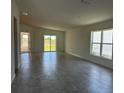 Spacious living room with tile flooring, natural light, and sliding door access to the backyard at 277 Harper Estates Cir, Lake Wales, FL 33859