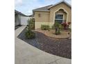 Tan house with walkway and nicely landscaped yard at 3362 Sebastion Ave, The Villages, FL 32163