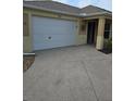 White double-car garage door with concrete driveway at 3362 Sebastion Ave, The Villages, FL 32163