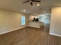 Open-concept living room and kitchen area with hardwood floors and natural light at 412 Avenue M Ne, Winter Haven, FL 33881