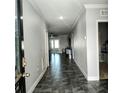 Inviting tiled hallway with neutral paint and trim leading to a living area with ceiling fan at 414 Taft Dr, Davenport, FL 33837