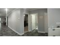 Spacious hallway featuring ceramic tile floors, neutral paint, and access to bedrooms and bathrooms at 414 Taft Dr, Davenport, FL 33837