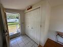 Bright entryway featuring tile floors and closet with boat view outside the door at 55808 Nan Dr, Astor, FL 32102