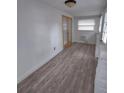 Bright sunroom with wood-look floors and French doors at 645 Cherry St, Daytona Beach, FL 32114