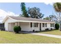 Inviting exterior view of this single Gathering home, featuring a carport, well maintained lawn, and freshly painted exterior at 708 Wynn Dr, Sanford, FL 32773