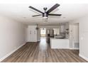 Open-concept living space showcasing modern flooring, updated lighting, and seamless flow to the adjacent kitchen at 708 Wynn Dr, Sanford, FL 32773