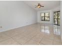Spacious living room with tile flooring and large windows at 7654 Sugar Bend Dr # 7654, Orlando, FL 32819