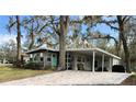 Lovely home features a brick-paved driveway and a charming teal front door at 106 Royal Palm Dr, Leesburg, FL 34748