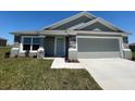 Inviting single-story home with a neutral color palette, stone accents, and a convenient attached garage at 1212 Caloosa Ridge Ave, Babson Park, FL 33827
