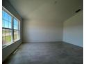 Bright living room with large windows, neutral walls, and modern tile flooring for a welcoming atmosphere at 1212 Caloosa Ridge Ave, Babson Park, FL 33827