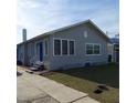 Charming one-story stucco home with a blue front door and a paved walkway at 134 Daytona Ave, Daytona Beach, FL 32117