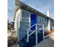 Corner view of the blue front door and white railing at 134 Daytona Ave, Daytona Beach, FL 32117