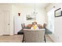 Comfortable dining room with table set for a meal, a refrigerator, and picture window at 1412 Mirabella Cir, Davenport, FL 33897