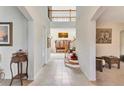 Inviting foyer showcases a staircase with wood and wrought iron details, leading to an open living area at 1447 Myrtle Oaks Trl, Oviedo, FL 32765