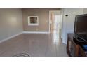 Living room features tile flooring and a small mirror on the wall at 1617 Shady Ridge Ct # 257, Orlando, FL 32807