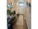 Inviting hallway with tile flooring, modern decor, and arched doorway at 207 Aidans Lndg, Haines City, FL 33844