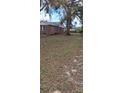 The property features a large backyard, ideal for outdoor activities and enjoying nature at 225 E Cummings St, Lake Alfred, FL 33850