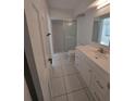 A clean bathroom featuring a glass-enclosed shower, toilet, and single sink vanity at 2449 E Lake Dr, Deland, FL 32724