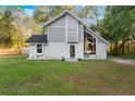 Charming home with freshly cut green lawn and new front landscaping at 2449 E Lake Dr, Deland, FL 32724